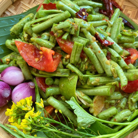 Thai long bean salad with tomatoes, shallots, yardlong beans, limes, and more.