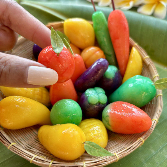 Colorful Thai luk chup mung bean dessert shaped like assorted fruits and vegetables.