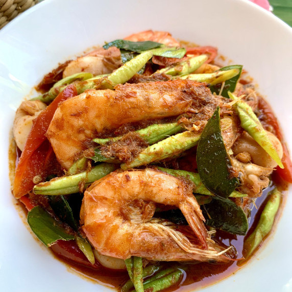 Top-down view of spicy Thai seafood stir-fry with shrimp and squid.
