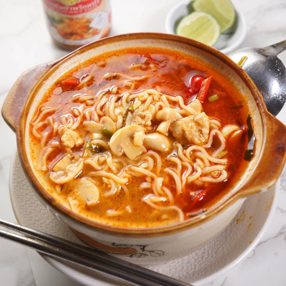 Tom Yum Noodle Soup in a bowl with Tom Yum Paste in the background