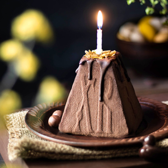 Photo of Vegan Ukrainian Easter Paska (No-Bake Chocolate Cheesecake Dessert) with the candle on top
