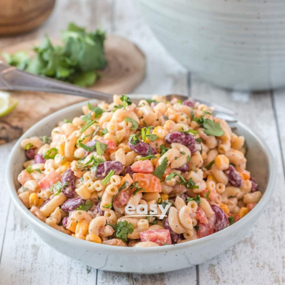 Vegan macaroni salad topped with chopped cilantro in a bowl