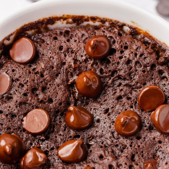 delicious vegan mug brownie with chocolate chips on top in a white mug