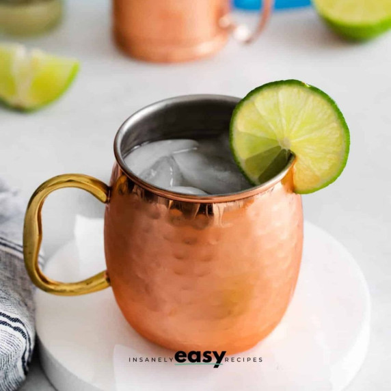 Iced London mule cocktail in a copper mug, with a lime wheel on the rim