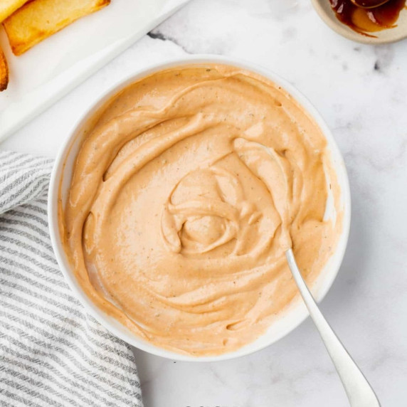 Barbeque ranch in a white bowl with a spoon