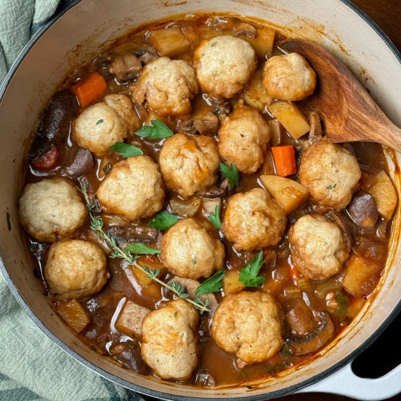 A big pot of vegan stew with dumplings.