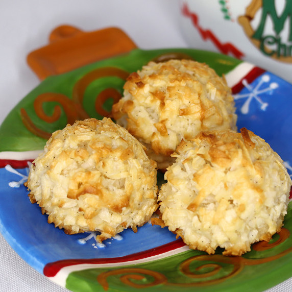 Vanilla Bean Coconut Macaroons arranged on a holiday plate against a white background