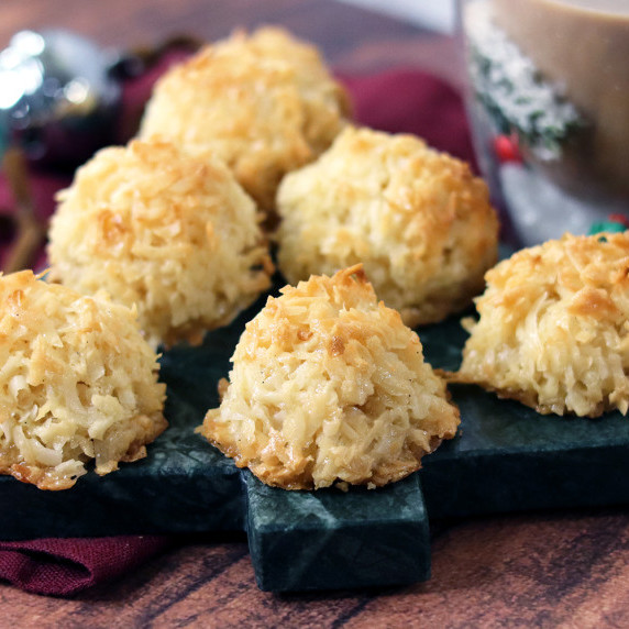 Vanilla Bean Coconut Macaroons arranged on a holiday plate against a white background