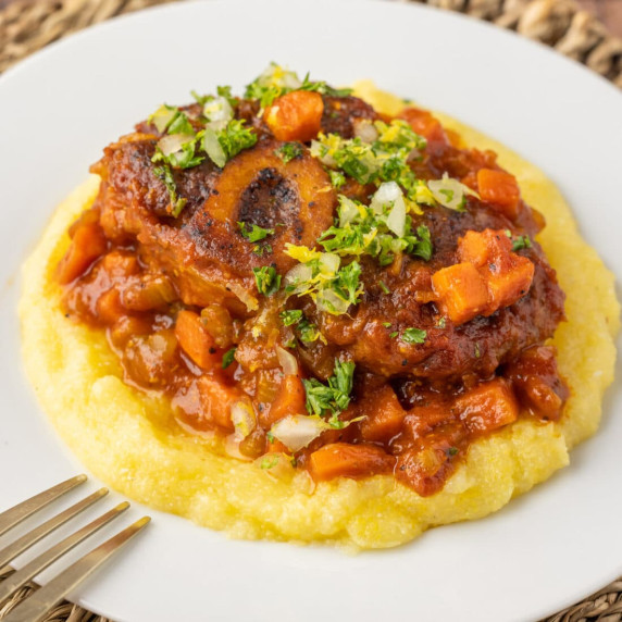 Veal Osso Buco is an Italian dish in which veal shanks are dredged in flour, seared for a crust, the