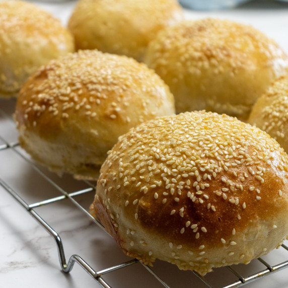Close up shot of a batch of vegan burger buns. Perfectly cooked with a good sprinkle of sesame seeds