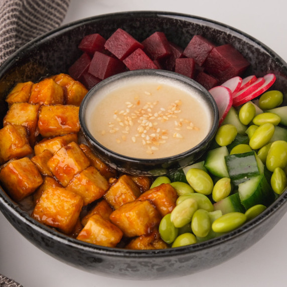 Vegan poke bowl with dressing in the middle