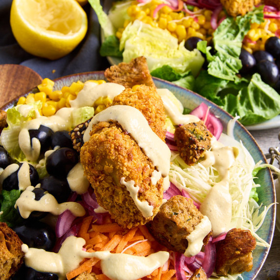 A plate of Vegetarian Caesar Salad with Crunchy Air Fryer Tofu