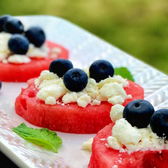 Watermelon, feta cheese and blueberry (Red, white and blue) appetizer ready to be served.