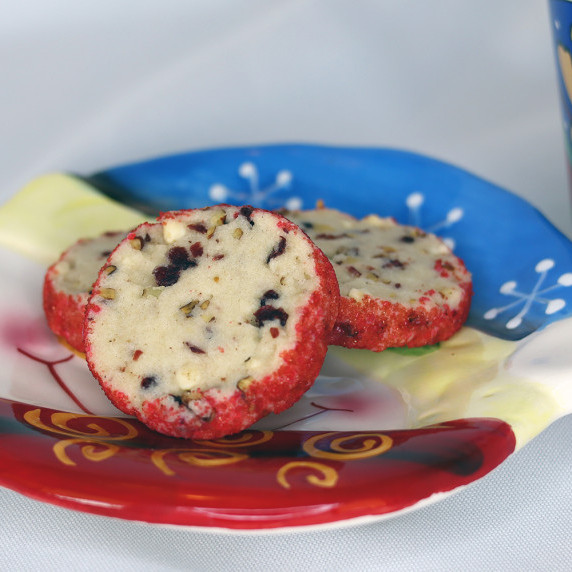 White Chocolate Cranberry Pecan Tea Cookies on a holiday plate against a white background.