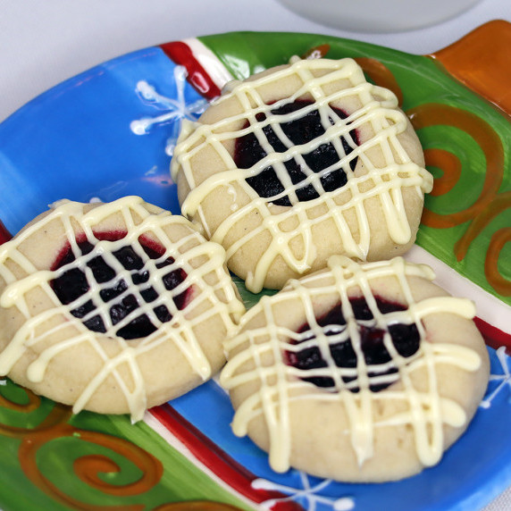 White Chocolate Cranberry Thumbprints arranged on a holiday plate