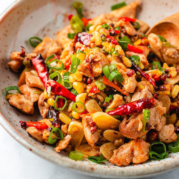 Chicken, chilis, scallions and cashew nuts in a white bowl