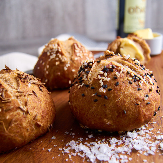 Sordough Pretzel buns sprinkled with sesame and caraway seeds