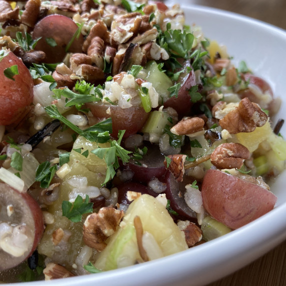 Wild rice salad in a white bowl.