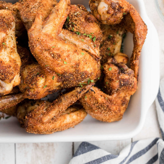 Close up of a dish full of Wingstop Louisiana Rub chicken wings.