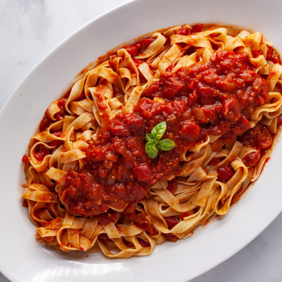 pasta with tomato sauce in serving bowl 