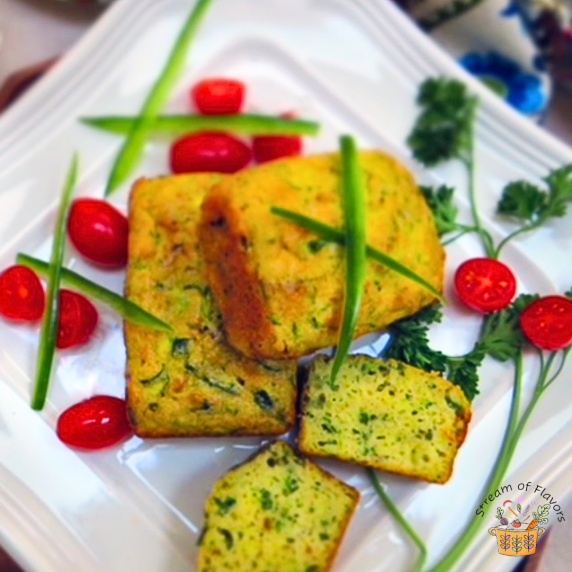 Zucchini Torta loaves with parsley and cherry tomatoes on a white plate