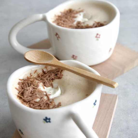 2 cups with passionfruit hot chocolate, chocolate shavings on top and cream 