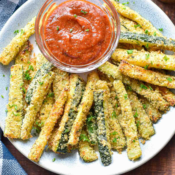 zucchini fries with marinara sauce on a plate.