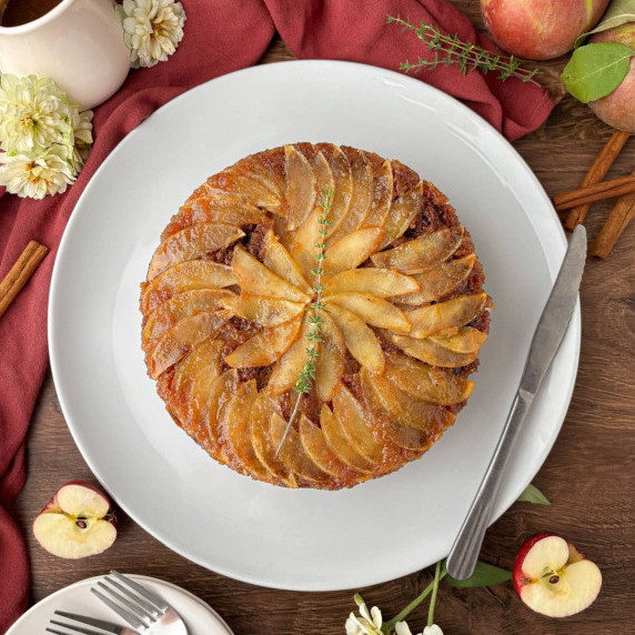 Top view of an Apple Upside Down cake on a white serving plate.