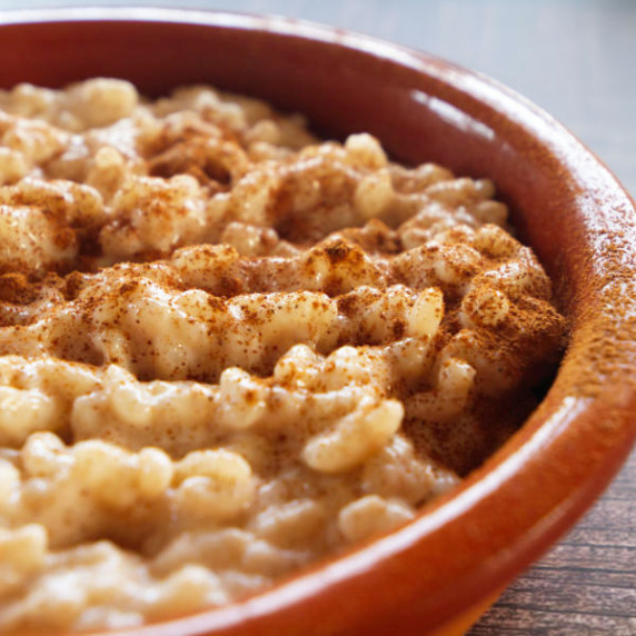 a bowl or arroz con leche with some ground cinnamon sprinkled over the top