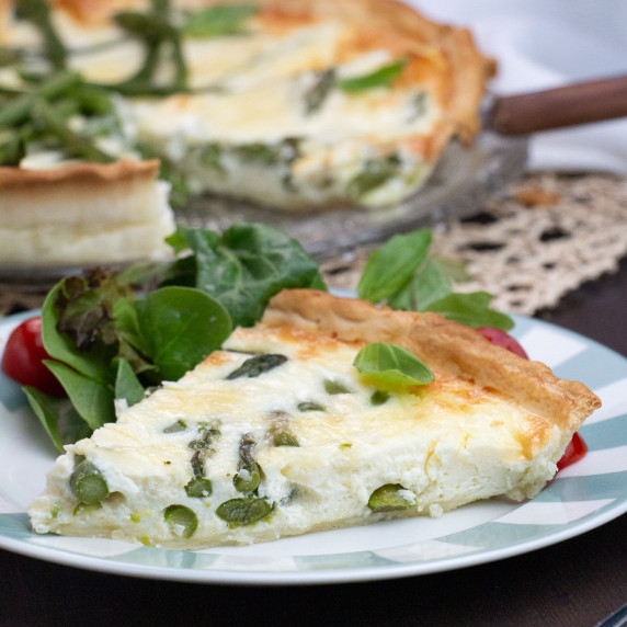 a piece of asparagus quiche with salad