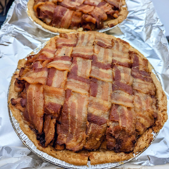 Two apple pies with bacon weave tops.