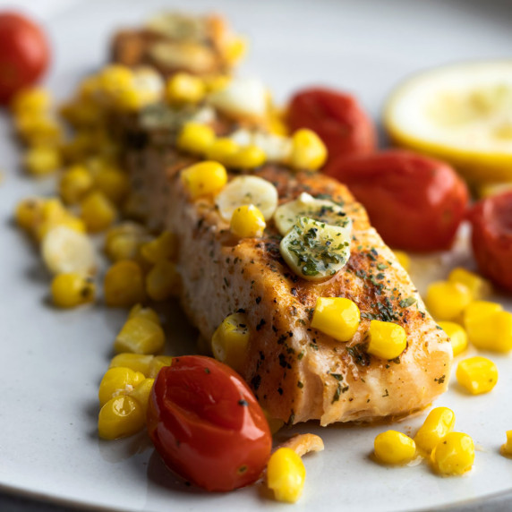 Baked salmon with veggies in a plate