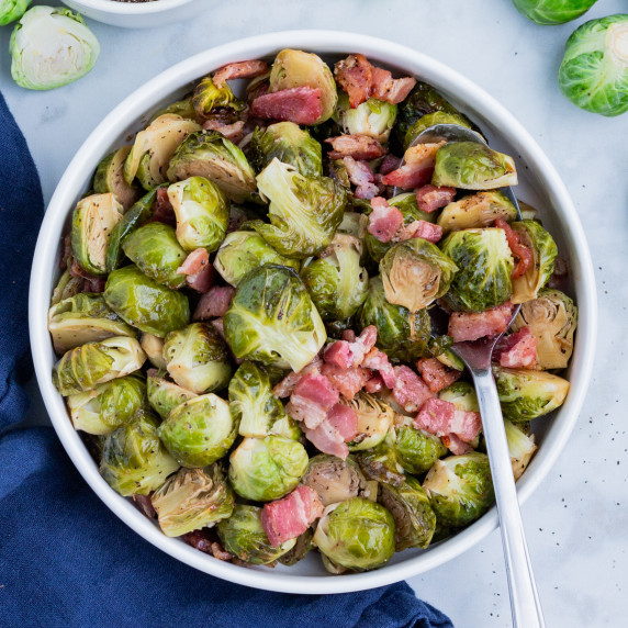 Balsamic Bacon Brussel Sprouts RECIPE served in a white bowl with a spoon.
