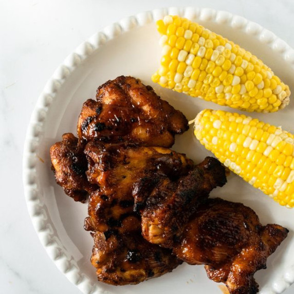 bbq chicken on a plate with corn.