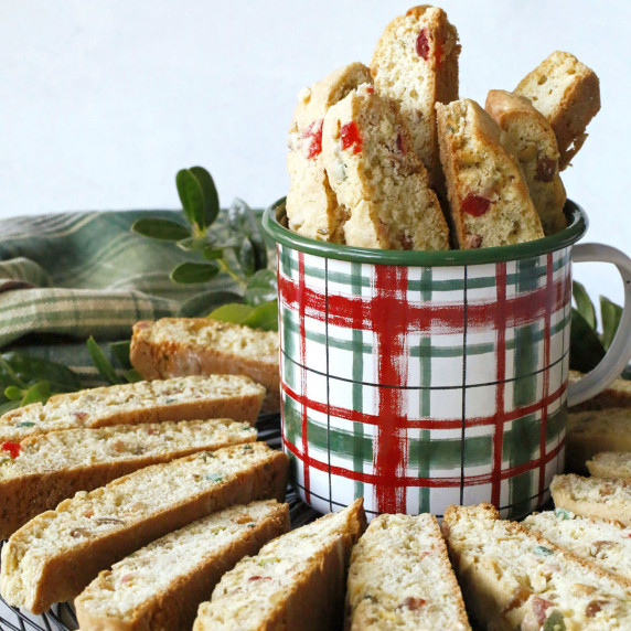 A plaid cup with candied fruit biscotti.