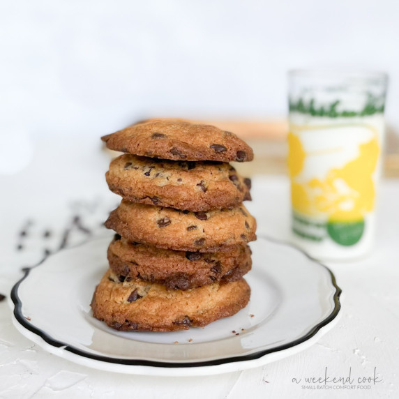 Stack of chocolate chip cookies and glass of milk.