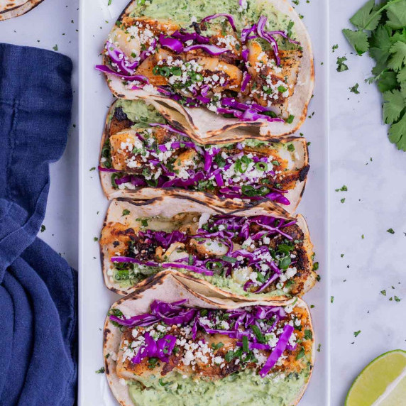 Blackened Fish Tacos with Avocado Sauce RECIPE served on a white platter.