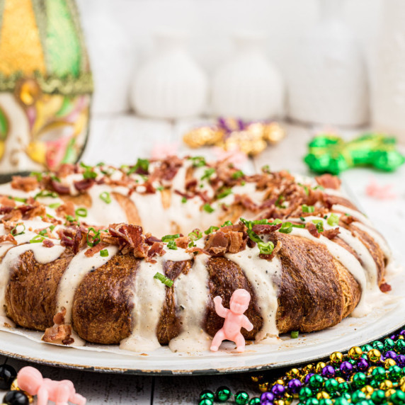 boudin stuffed king cake with a king cake baby in front