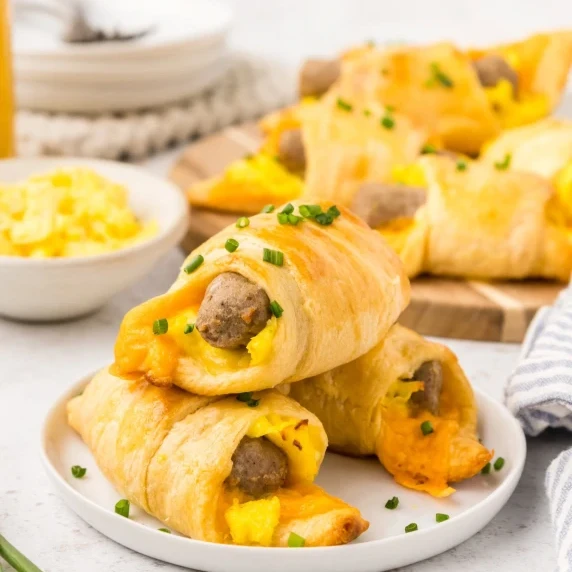 Breakfast Crescent Rolls stacked on a small white plate.