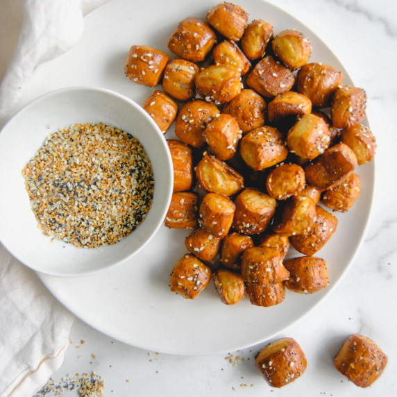 brown butter everything pretzel bites on white plate and marble background