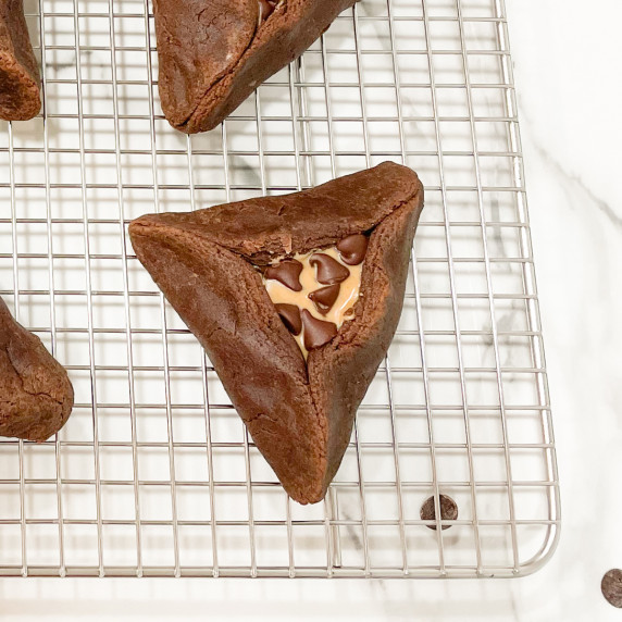 chocolate brownie hamantaschen cooling on a rack