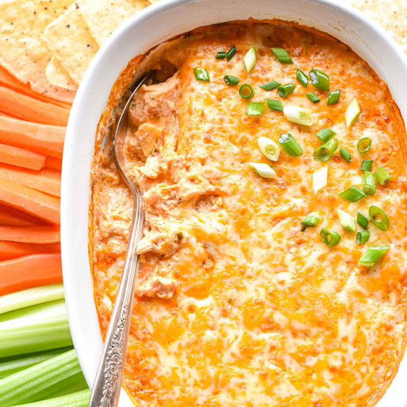 high protein buffalo chicken dip in a white baking dish.