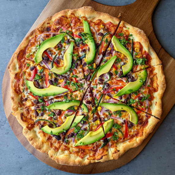 A California style veggie pizza topped with fresh avocado slices