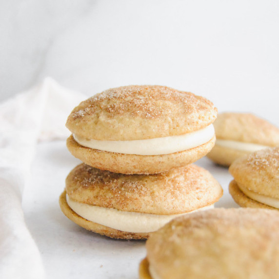 caramel snickerdoodle whoopie pies in a stack on marble background