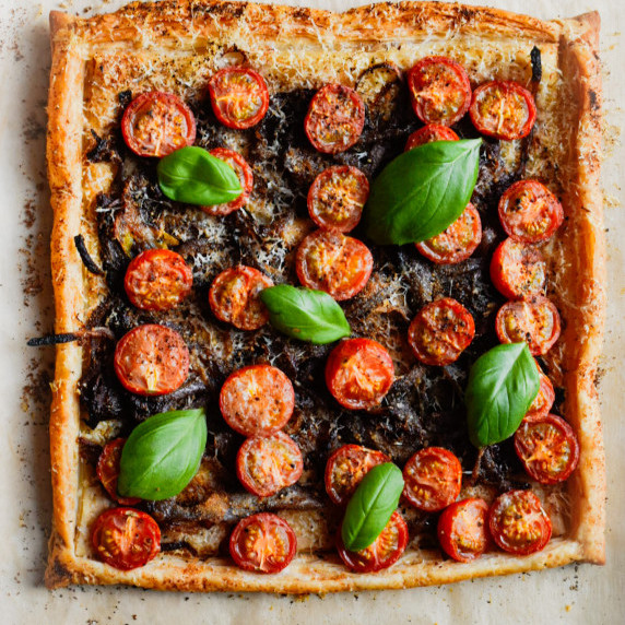 puff pastry tart with caramelized onions, tomatoes and basil