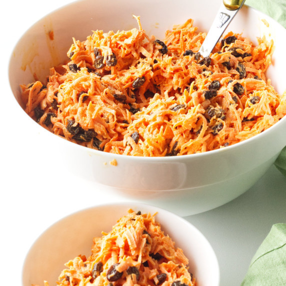 bowl of chick-fil-a carrot raisin salad in a bowl on a white background.