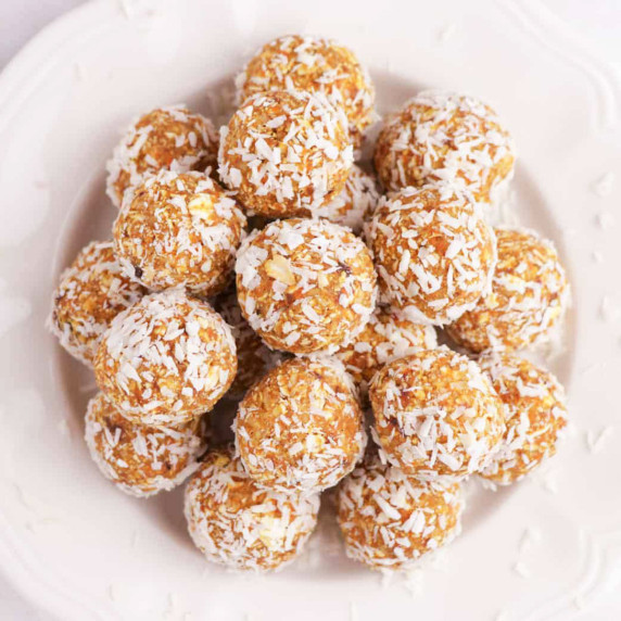 Carrot cake bliss balls on a white plate.