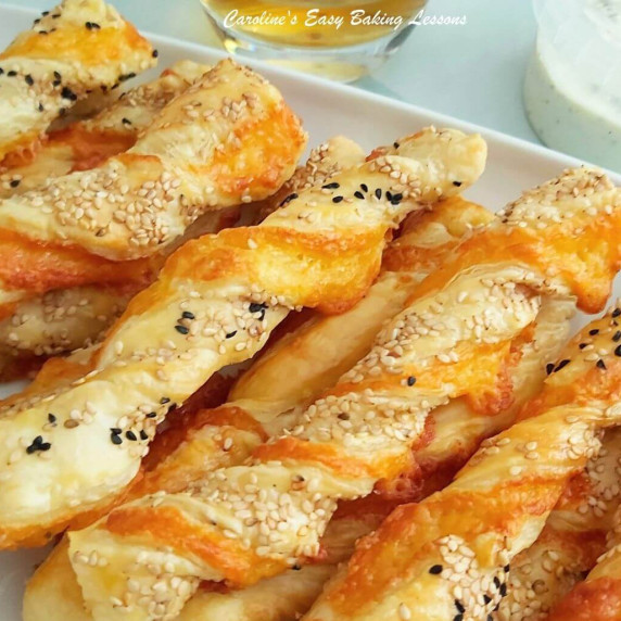 Extra close shor of cheese filled puff pastry twists with sessame seeds.