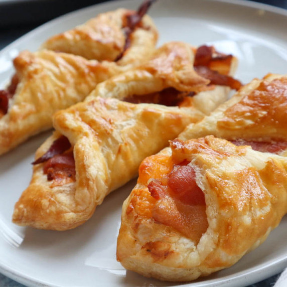 white plate with cheese bacon turnovers
