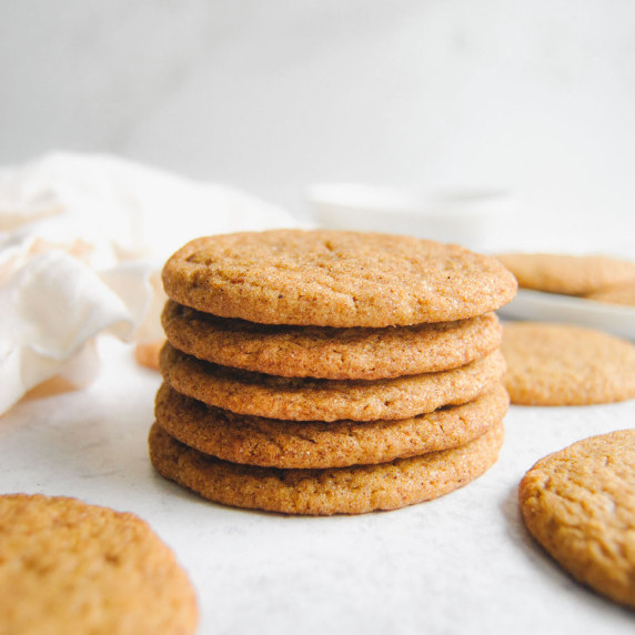 stack of chewy pumpkin molasses cookies on marble background